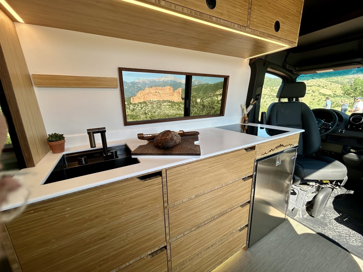 Forest kitchen with wood cabinetry and a white countertop