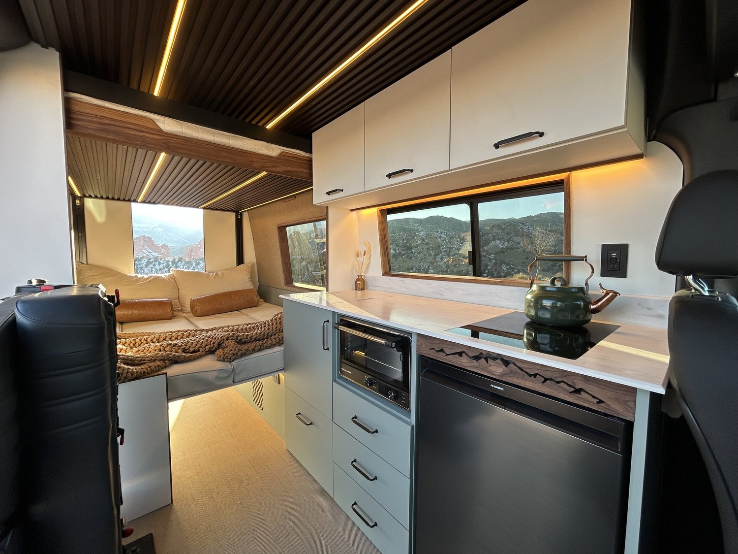 Warm wood, pale cabinetry and mountain views inside a custom build