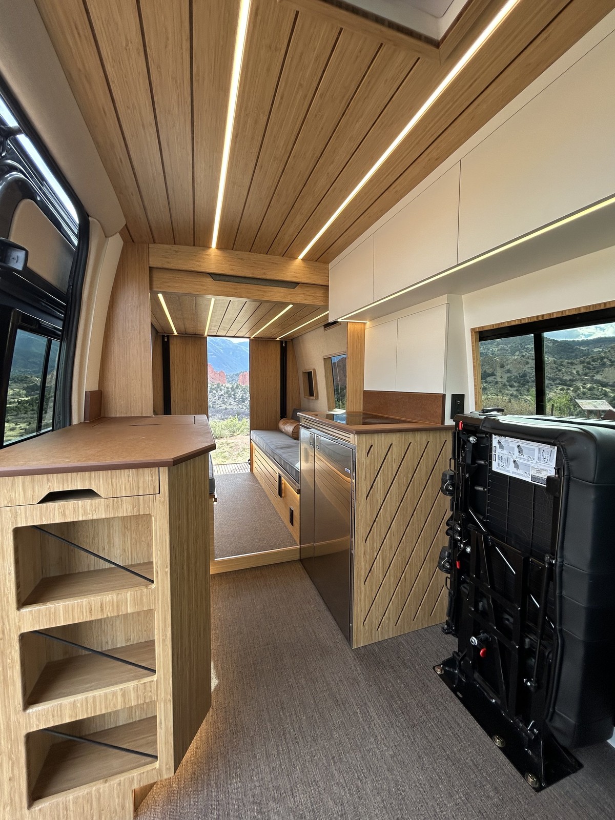 The Den interior with the second-row passenger bench folded against the side wall.