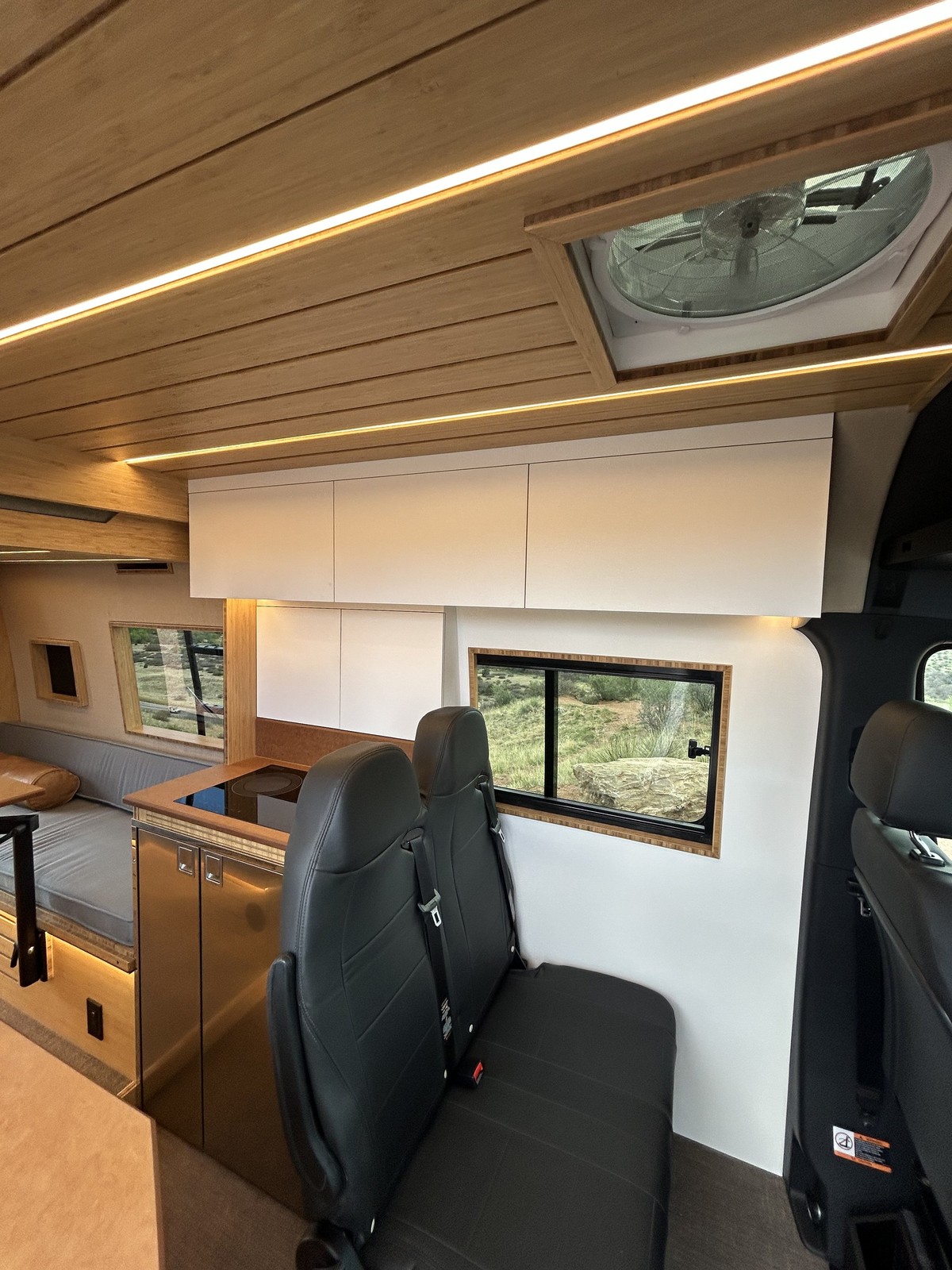 The Den passenger bench, upper cabinets, roof fan and illuminated wood slat ceiling.