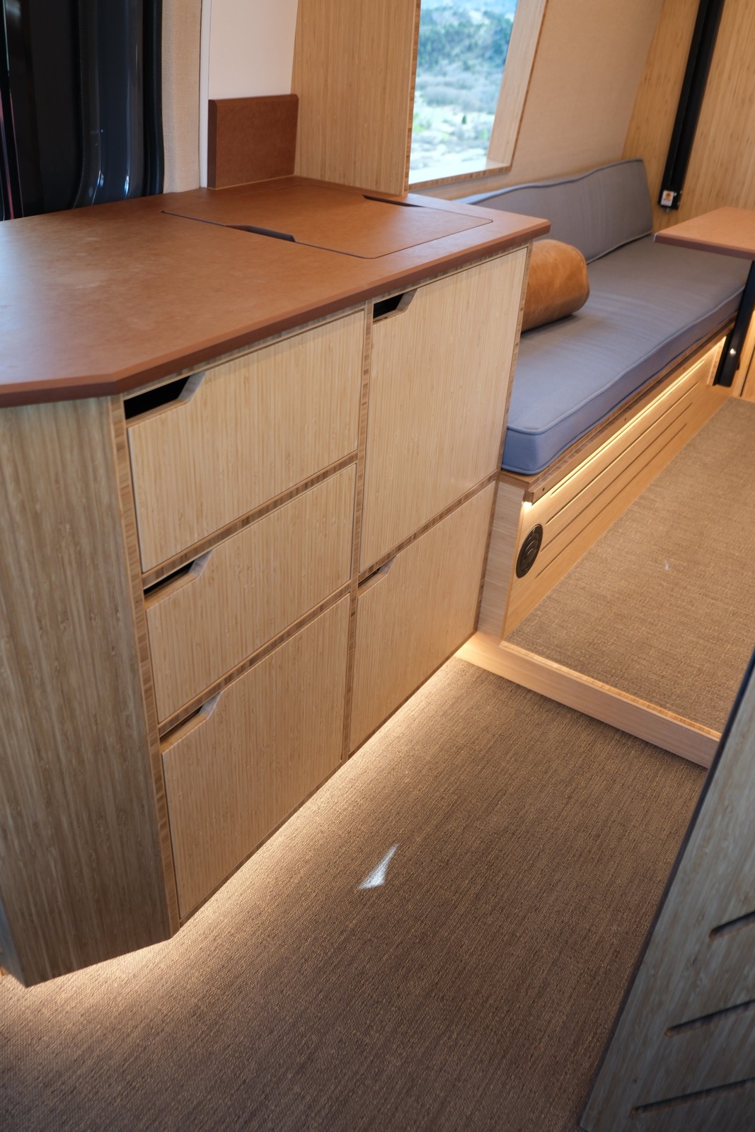 The Den lower galley drawers beneath a wood countertop.