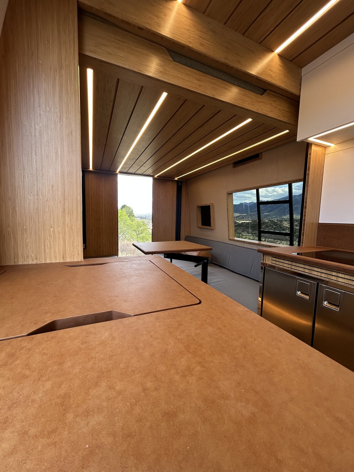 The Den wood galley countertop opposite the lounge under the raised elevator bed.