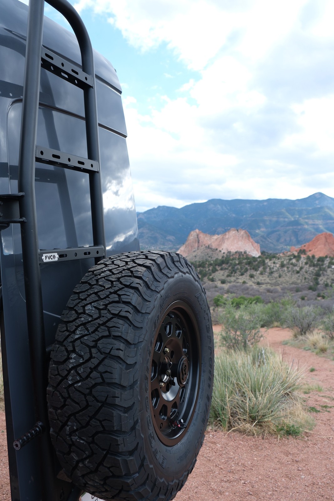 The Den rear spare tire mounted beneath the exterior ladder.