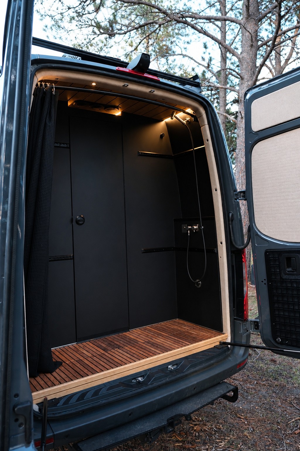 The Den rear wet bath with a teak floor mat and warm ceiling lights.