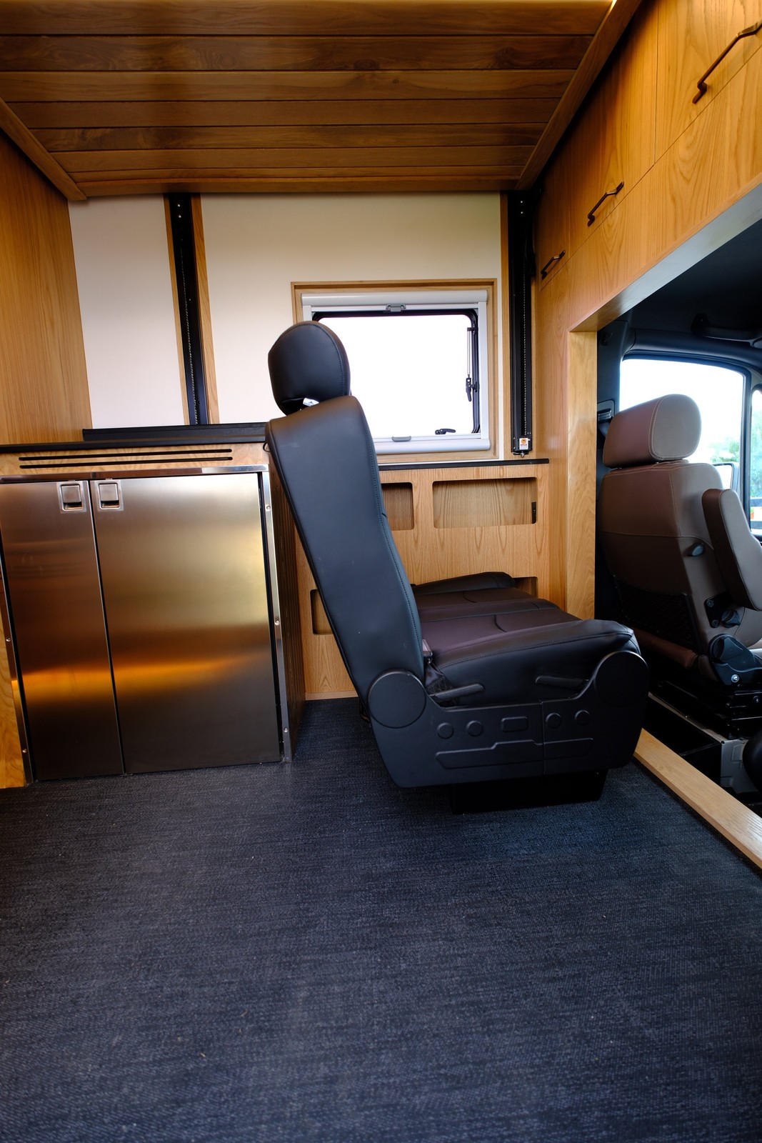 Side view of the Nest second-row passenger bench beside the refrigerator.